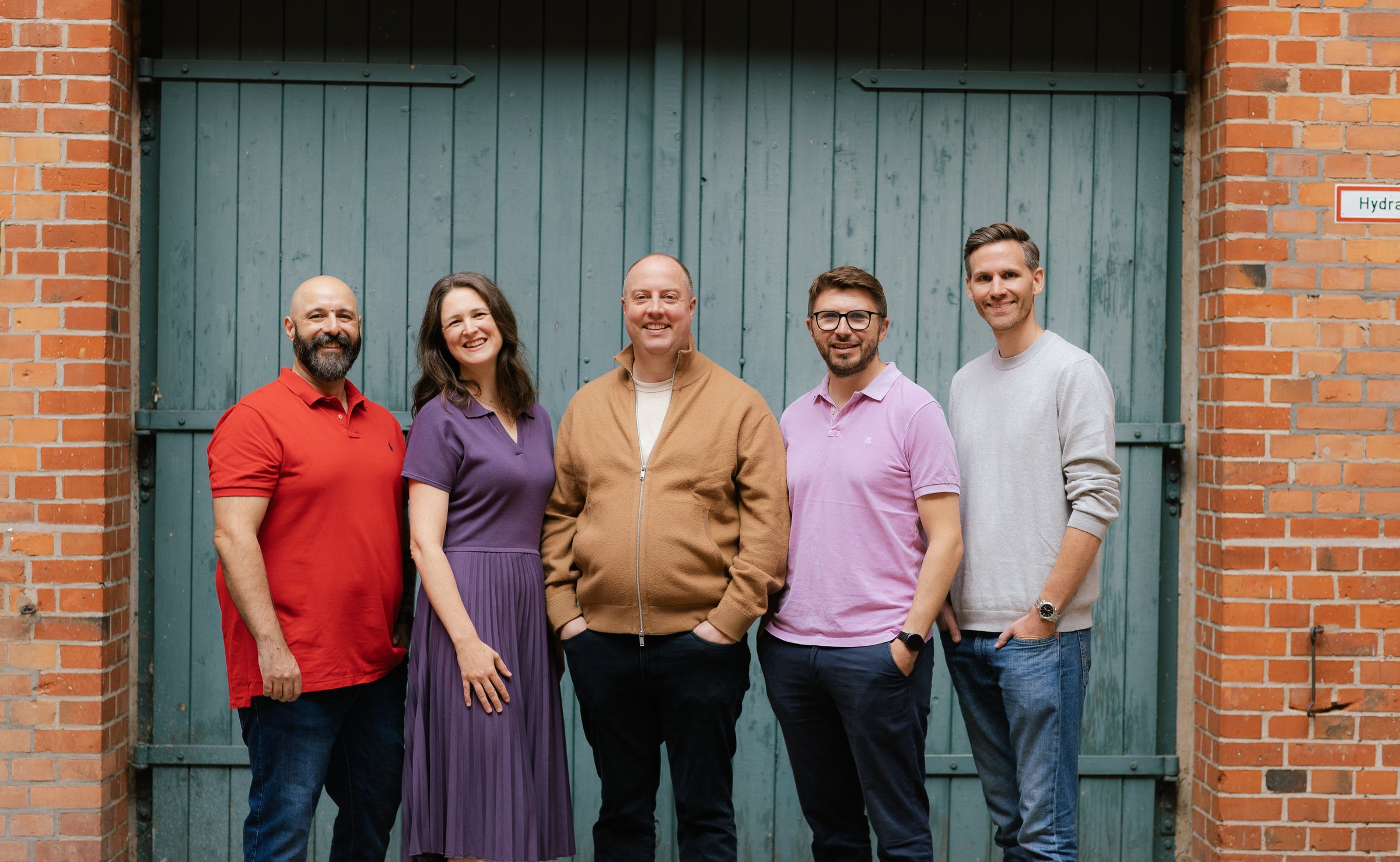 The WhyBrilliant team, standing together outside the Berlin workshop the company works from.